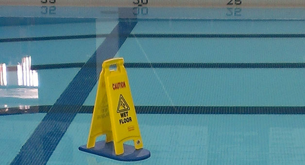 wet floor sign swimming in pool